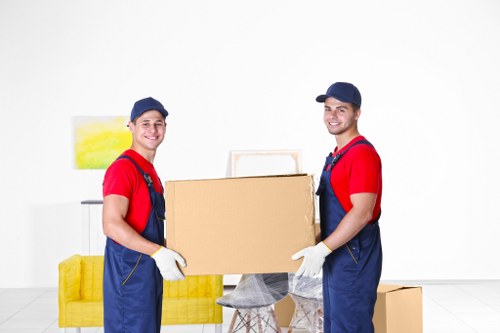 Professional house movers loading furniture on a residential street in Fulham