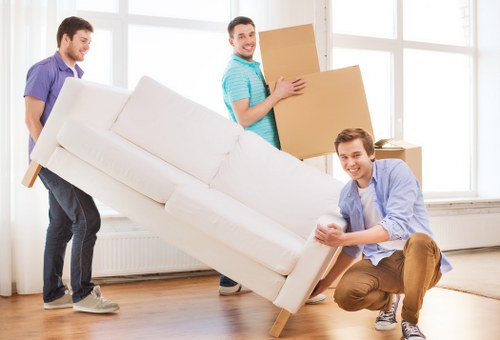 Local moving team handling boxes and furniture in Fulham flat