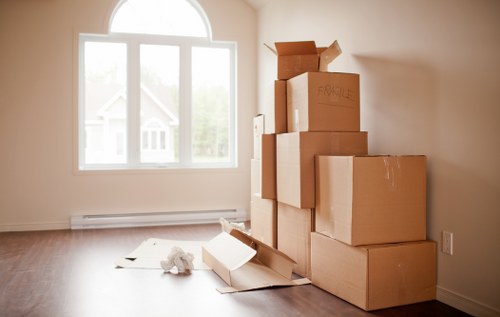 Moving team carrying furniture from a Fulham apartment with stair access