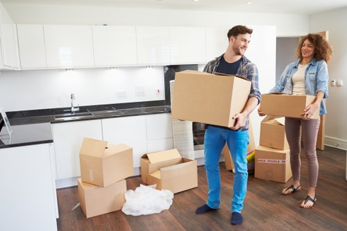 Professional movers handling household items in a Fulham flat